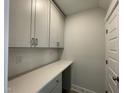 Convenient laundry room with white cabinets, ample counter space, and a clean, modern design at 486 Traditions Grande Blvd # 28, Wake Forest, NC 27587