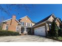 Traditional brick home with a well-manicured lawn and attached garage at 502 Willowmere Ct, Cary, NC 27513