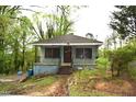 Charming, bungalow-style home featuring a small porch and mature trees at 537 Homeland Ave, Durham, NC 27707