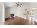 Open living room with hardwood floors, a fireplace, and access to the kitchen and dining area at 5500 Fortunes Ridge Dr # 72A, Durham, NC 27713