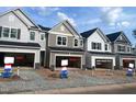 Row of new two-story townhomes with two-car garage in a new community development at 6002 Shade Tree Ln, Durham, NC 27703
