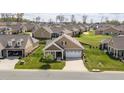 Beautiful aerial view of the home with well-manicured lawn and neighborhood at 667 Ashley Woods Dr, Gibsonville, NC 27249