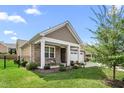 Charming home featuring a covered entryway and stone accents at 667 Ashley Woods Dr, Gibsonville, NC 27249