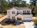 Newly constructed two-story home with stone accents, a front porch, and an attached garage at 68 Tee Time Ter, Benson, NC 27504