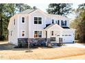 Beautiful two-story home with stone accents, a covered front porch, and an attached garage at 68 Tee Time Ter, Benson, NC 27504