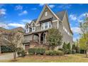 Charming home with a covered front porch, well-maintained landscaping, and a two-car garage at 8121 Greys Landing Way, Raleigh, NC 27615