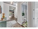 Welcoming foyer with hardwood floors, an eye-catching rug, and a glimpse of the living spaces at 8121 Greys Landing Way, Raleigh, NC 27615