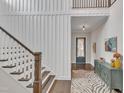Elegant staircase with white railings and wooden steps, complemented by stylish wall paneling at 8121 Greys Landing Way, Raleigh, NC 27615