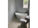 Relaxing bathroom with a freestanding tub, stylish faucet, and tiled floor, ready for spa days at 905 Ardmore Dr, Durham, NC 27713