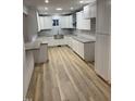 Spacious kitchen featuring shaker style cabinets, granite countertops, and new flooring at 905 Ardmore Dr, Durham, NC 27713