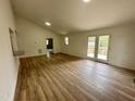 Open living room featuring new floors, recessed lighting, and access to back deck at 905 Ardmore Dr, Durham, NC 27713