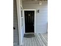Entrance to unit 201 featuring a black door, gold numbers, and a 'Home' welcome mat at 1140 Carlton Ave # 201, Raleigh, NC 27606