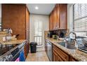 Functional kitchen with wood cabinets, granite countertops, and stainless steel appliances at 130 E Longview St # Apt K, Chapel Hill, NC 27516