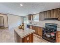 Inviting kitchen showcasing island, wood cabinets, countertops, and modern stainless steel appliances at 1326 Stephens Dr, Roxboro, NC 27573