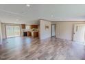 Bright, open-concept living space featuring wood-look floors and seamlessly connecting to the kitchen at 1326 Stephens Dr, Roxboro, NC 27573