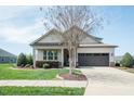 Well-maintained home featuring a neat front lawn, flowerbeds, and a driveway at 135 Brocks Trce, Burlington, NC 27215