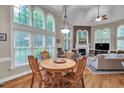 Bright breakfast area with large windows, a round table, and seamless access to living room at 1404 Rhea Dr, Garner, NC 27529
