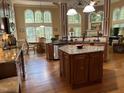 Spacious kitchen with granite countertops, wooden cabinets, stainless steel appliances, and large windows at 1404 Rhea Dr, Garner, NC 27529