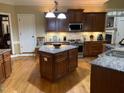 Well-equipped kitchen featuring granite countertops, stainless steel appliances, and a functional center island at 1404 Rhea Dr, Garner, NC 27529