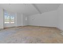 Unfinished bonus room with natural light from large windows, offering versatile space for customization at 1425 Lake Adventure Ct, Raleigh, NC 27613