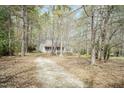 Secluded home surrounded by mature trees, offering privacy and natural beauty at 1508 Middle Ridge Dr, Willow Springs, NC 27592