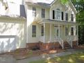 Lovely two-story home features a welcoming front porch with a brick foundation and vinyl siding at 1623 Rogers Pointe Ln, Creedmoor, NC 27522