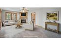 Cozy living room boasts a stone fireplace, hardwood floors, and tons of natural light through many windows at 167 Coachmans Cove Rd, Four Oaks, NC 27524