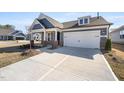 Attractive exterior view with well-manicured lawn, spacious driveway and a mix of brick and siding accents at 1801 Angelonia Way, Fuquay Varina, NC 27526