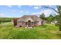 Spacious backyard featuring a stone patio and lush green lawn perfect for outdoor enjoyment at 2011 Gibsonville Ossipee Rd, Elon, NC 27244