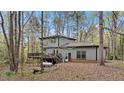 Backyard of a two-story home featuring a deck and stairs at 206 Rocky Hills Rd, Pittsboro, NC 27312