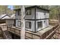 Exterior shot of the home with the spacious deck and wooded surrounding area at 206 Rocky Hills Rd, Pittsboro, NC 27312