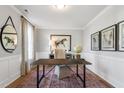 Charming home office with neutral colors, hardwood floors, large desk, and natural light at 229 Savannah Moss Way # 121, Raleigh, NC 27603