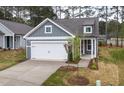 Charming home showcasing a gray exterior, white trim, and a two-car garage at 2304 Beeblossom Pl, Fuquay Varina, NC 27526