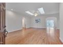 Spacious living room featuring hardwood floors, skylights, and an open layout for comfortable and modern living at 2411 Lynch Store Rd, Mebane, NC 27302