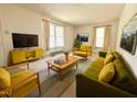 Bright living room with large windows, comfortable seating, and stylish mid-century modern decor at 2501 Landis Dr, Durham, NC 27705