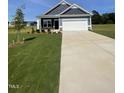 Charming one-story home featuring a two-car garage, a green lawn, and minimal landscaping at 291 Deodora Ln, Cameron, NC 28326