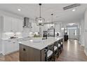 Spacious kitchen with large center island, white cabinets, stainless appliances and pendant lighting at 303 Augusta Pond Way # 166, Raleigh, NC 27603