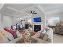 Cozy living room boasts coffered ceilings, gas fireplace, plush seating and abundant natural light at 303 Augusta Pond Way # 166, Raleigh, NC 27603