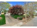 A long driveway leads to the detached garage; house is surrounded by lush greenery at 306 Perry St, Raleigh, NC 27608