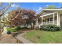 Exterior view of home showcasing the front yard with mature trees and landscaping at 306 Perry St, Raleigh, NC 27608