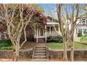 Charming home exterior with stone-lined entry steps, a covered porch, and lush landscaping at 306 Perry St, Raleigh, NC 27608
