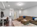 Open-concept living room with hardwood floors, a plush sectional sofa, and access to a bathroom at 3103 Stockdale Dr, Raleigh, NC 27609