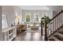 Cozy living room featuring hardwood floors, natural light, stylish furniture, and a staircase at 3103 Stockdale Dr, Raleigh, NC 27609