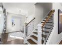 Inviting foyer with hardwood floors, staircase with iron railings, and an abundance of natural light at 311 Augusta Pond Way # 168, Raleigh, NC 27603