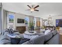 Spacious living room featuring hardwood floors, a ceiling fan, and large windows providing ample natural light at 311 Augusta Pond Way # 168, Raleigh, NC 27603