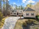 Charming home featuring manicured landscaping, brick accents, and a spacious driveway at 36 Wellspring Cir, Clayton, NC 27527