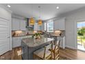 Bright kitchen featuring granite countertops, a kitchen island with bar seating, and modern appliances at 6 S Summerhill Rdg, Clayton, NC 27520