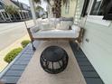 Relaxing front porch with swing, pillows, and a decorative table at 65 Oglethorpe Ave, Clayton, NC 27527