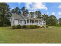 Charming single-story house with a side porch, complemented by a well-manicured lawn at 664 Marler Rd, Benson, NC 27504