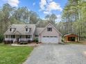 Well-maintained home boasting a spacious front yard, a front porch, and a convenient two-car garage with an attached shed at 707 Sinai Cir, Hillsborough, NC 27278